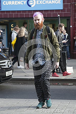 A man with pink hair crossing the road in Oxford Street. Editorial Stock Photo