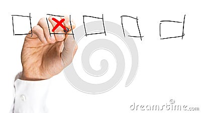 Man placing a red cross in a set of check boxes Stock Photo