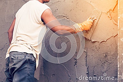 Man plasterer concrete working at wall Stock Photo