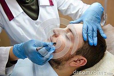 Man in plastic surgery clinic making operation plan Stock Photo