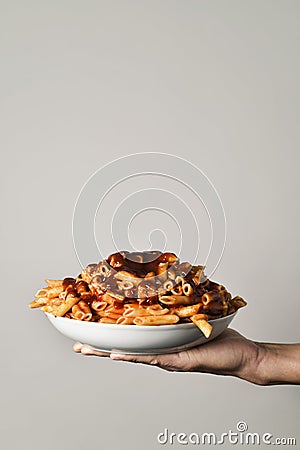 Man with a plate of pasta with tomato sauce Editorial Stock Photo