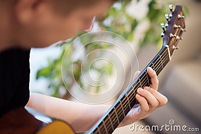 A man playing an acoustic guitar closeup. Learning music Stock Photo