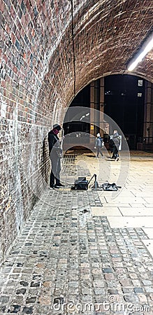 Man playing alone in London on the Street Editorial Stock Photo
