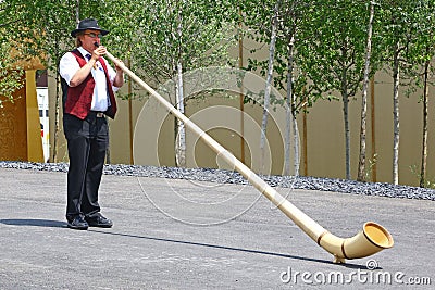 Man playing alphorn in Expo 2015, Milan Editorial Stock Photo