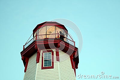Bagpiper on Top of Illumined Lighthouse Stock Photo