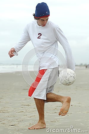 Man playing beach soccer Stock Photo