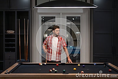 Man playing billiards in the billiard club. Stock Photo