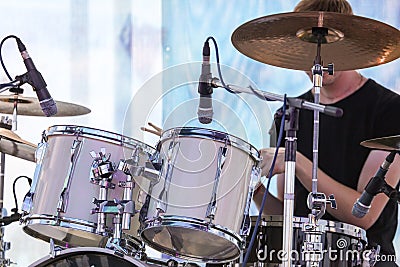 Man playing drums on stage Stock Photo