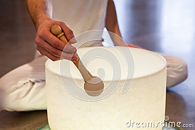 Man playing crystal bowl healing music Stock Photo