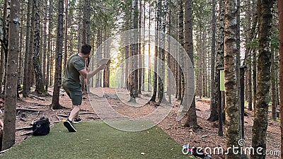 Man playing disc golf in the forest in Norway with a beautiful landscape Stock Photo