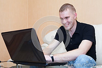 Man playing in games on laptop Stock Photo