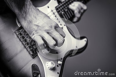 Man playing guitar. Close up hand playing guitar. Musician playing guitar, live music. Musical instrument. Black and Stock Photo