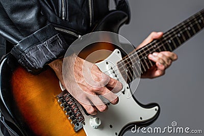 Man playing guitar. Close up hand playing guitar. Musician playing guitar, live music. Electric guitar. Repetition of Stock Photo