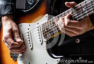 Man playing guitar. Close up hand playing guitar. Musician playing guitar, live music. Musical instrument. Electric Stock Photo