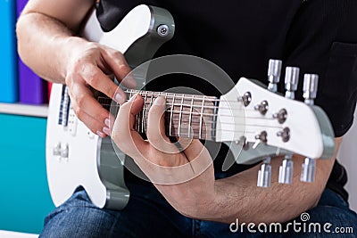 Man playing guitar his favourite song Stock Photo