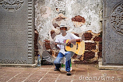 A man playing guitar at St. Paul church in Meleka, Malaysia Editorial Stock Photo
