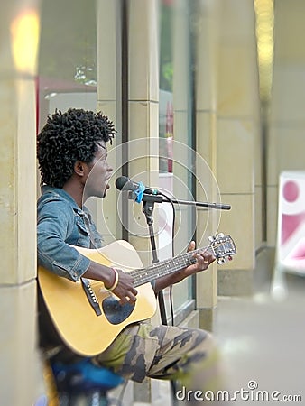 Man playing guitar in the street. Musician on the street. Editorial Stock Photo