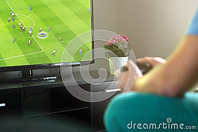 Man playing imaginary soccer or football console game on tv. Stock Photo