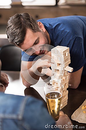 Man playing jenga game Stock Photo