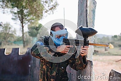 Man Playing Paintball in the forest Editorial Stock Photo