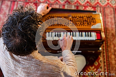 Man playing soulful music with harmonium Stock Photo