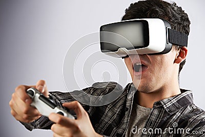 Man Playing Video Game Wearing Virtual Reality Headset Stock Photo
