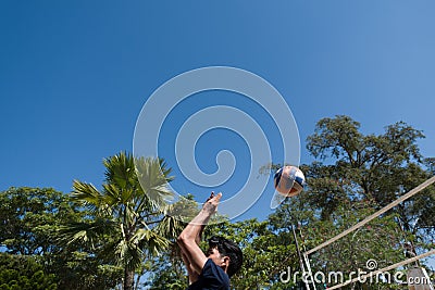 Young man playing volleyball outdoors Editorial Stock Photo