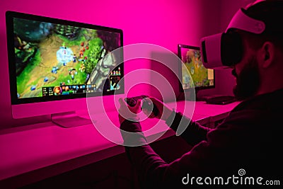 Man playing VR game on computer Stock Photo