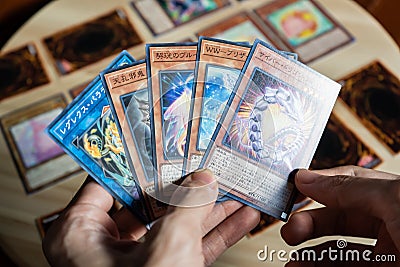 A man playing Yu-Gi-Oh trading card game. Editorial Stock Photo