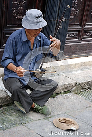 Man plays erhu, a traditional chinese instrument Editorial Stock Photo