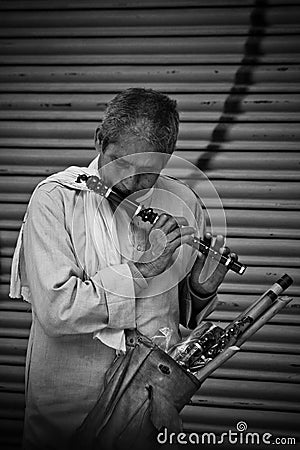 A man plays a flute ready to sell on the streets of Kathmandu, Nepal Editorial Stock Photo