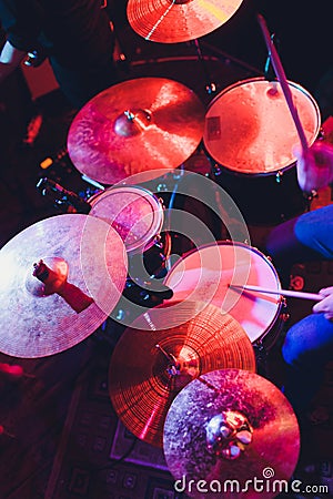 Man plays musical percussion instrument with sticks closeup on a black background, a musical concept with the working drum, Stock Photo