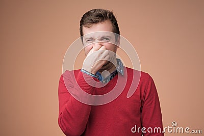 Man plugs nose as smells something stink Stock Photo