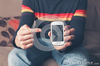 Man pointing at broken smart phone Stock Photo