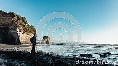 Man pointing with finger at what used to be Elephant rock, New Plymouth, New Zealand in 2020 Stock Photo