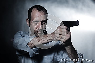 Man pointing gun Stock Photo