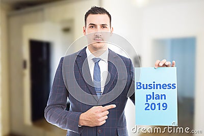 Man pointing at paper with business plan for year Stock Photo