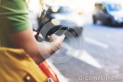 Man pointing on screen smartphone on background cars, tourist hipster waiting using in hands mobile phone, traveler connect wifi Stock Photo