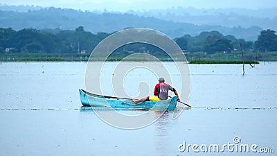 Man poling a boat in La Segua Wetland Editorial Stock Photo