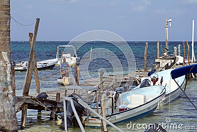 Man in a wooden boat by a pier Editorial Stock Photo