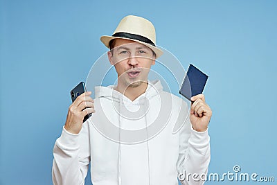 Man portrait tourist with a passport in hand, man in the hat Stock Photo