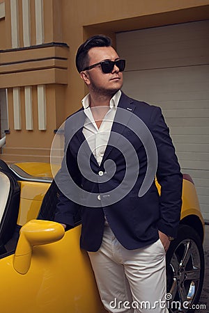 Man posing with convertible sportcar Stock Photo