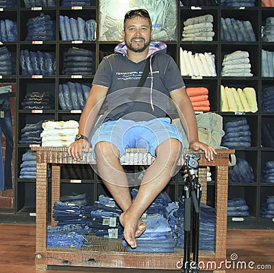 Man posing in denim jeans shop Stock Photo
