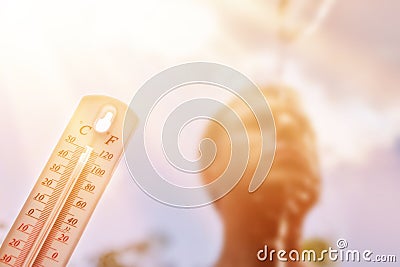 Man pouring water on his head in extreme heat, Thermometer in summer day shows or indicate high temperature Stock Photo