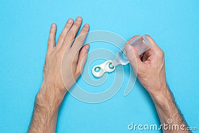 A man pours a contact lens solution. Hygiene of colored lenses. Health care. Disinfection. Stock Photo