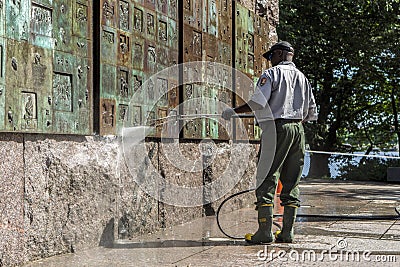 Man power washes monumnet. Editorial Stock Photo