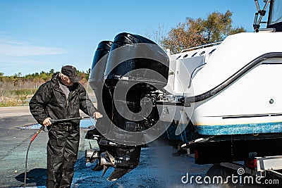 Man power washing outboard motors Stock Photo