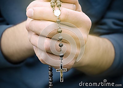 Man prays with a rosary Stock Photo