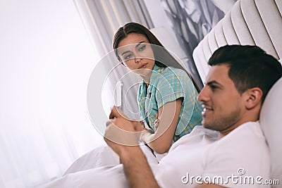 Man preferring smartphone over spending time with his girlfriend. Jealousy in relationship Stock Photo