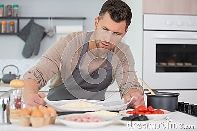 Man preparaing pizza at home Stock Photo